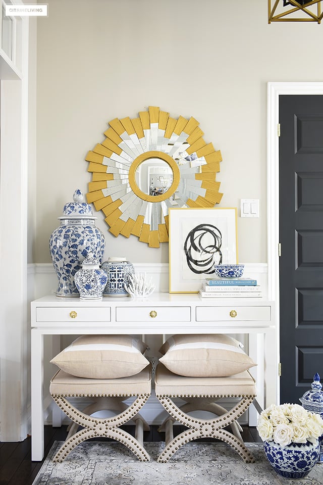 Style your console table with chic blue and white ginger jars and vases layered with design books and modern art for a sophisticated modern look.