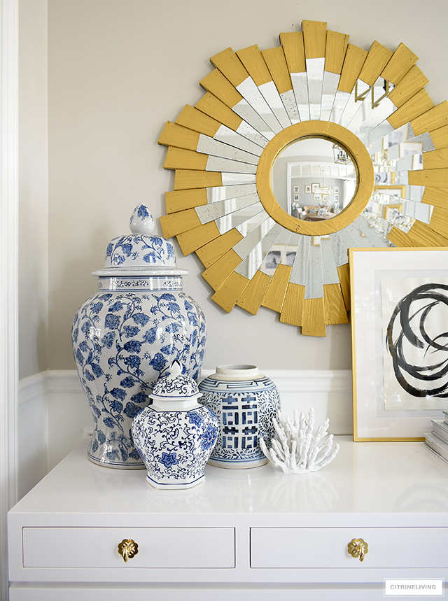Console table styling ideas with blue and white ginger jars, coral sculptures and modern art.