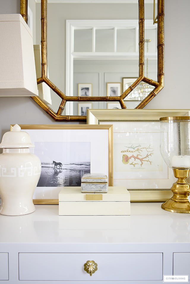 Style a console table with a coastal-chic vibe using beach-themed framed artwork.