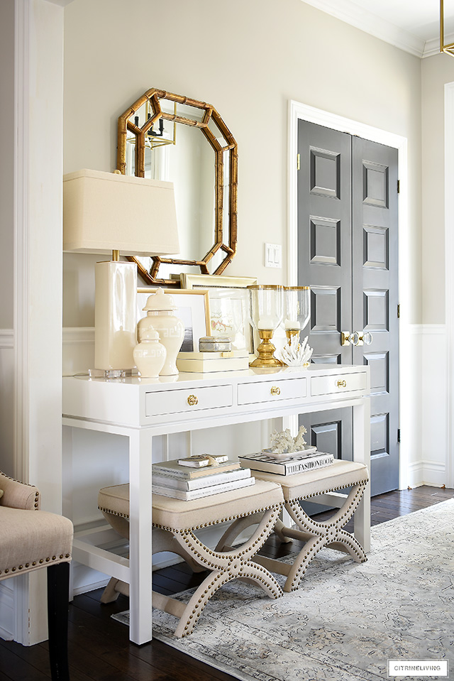 A gorgeous console table with a coastal-chic look! Layer neutral accessories and art for a classic look.