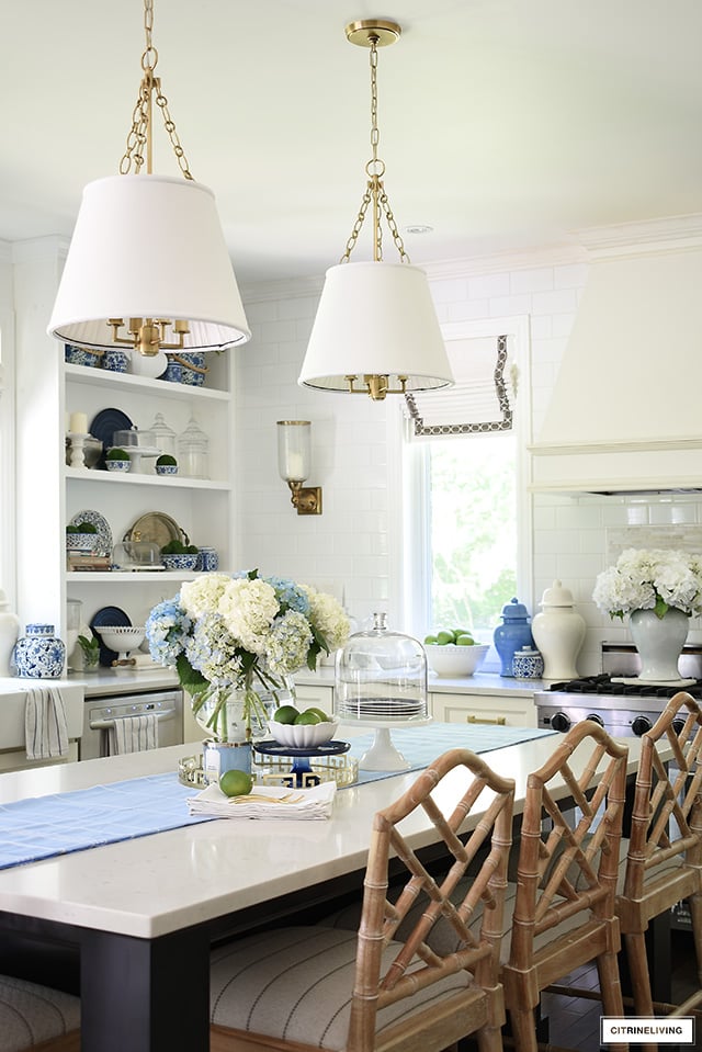 Kitchen island decorated for summer with blue and white hydrangeas.