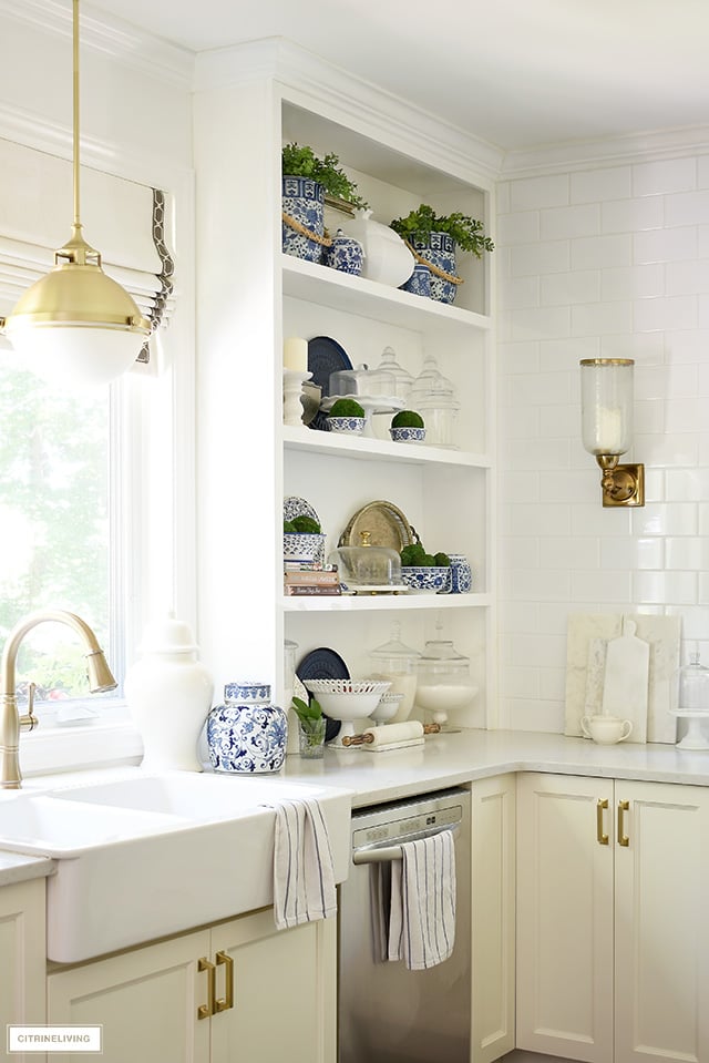 Built-in kitchen shelves with blue and white chinoiserie and touches of greenery.