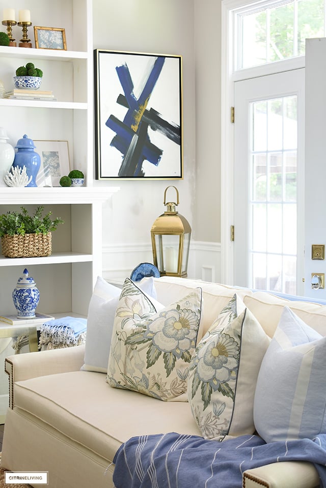 Summer decorated living room with beautiful blue, green, floral prints and natural elements creates breezy, casual look!