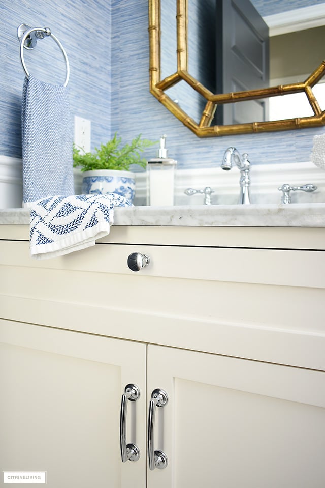 Elegant coastal-chic bathroom with classic details - white vanity, silver hardware and accessories.