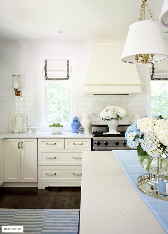 Summer kitchen decorating - blue and white striped rugs, ginger jars and hydrangeas for a crisp and airy feel.