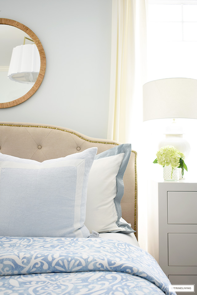 Summer bedroom decorating, blue and white bedding, rattan mirror 