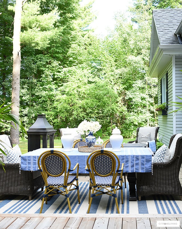 Backyard dining table with wingback chairs and bistro chairs.