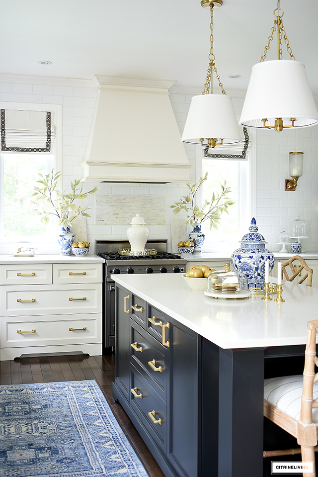 Beautiful and elegant kitchen with blue and white porcelain, gold faux fruit and branches for fall.