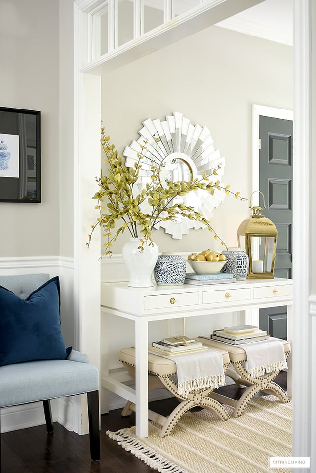 Entryway decorating with blue and white ginger jars, gold accents and soft neutral layers for fall.