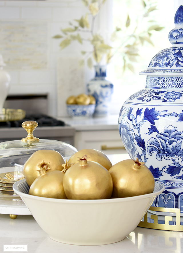 Faux painted gold pomegranates are an elegant accessory for fall decor. 