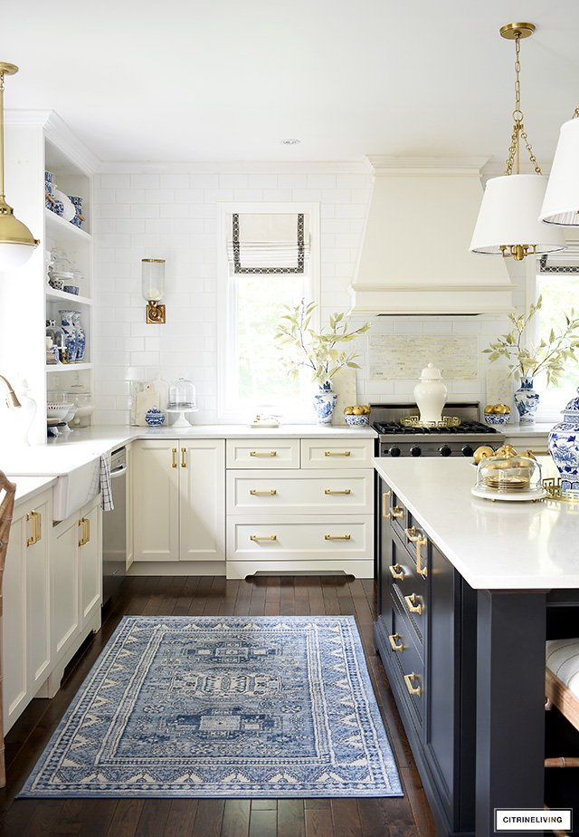 Kitchen decorated for fall with a gorgeous blue, white and gold color palette.