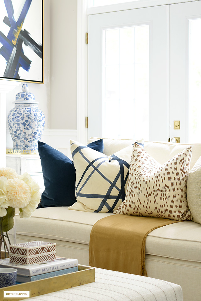A beautiful mix of chic and elegant throw pillows - navy velvet, Kelly Wearstler channels in navy and Les Touches in Tan.