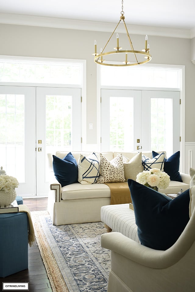 French doors, with transoms let in beautiful natural light in this chic and elegant living room! Fall decorating in navy, brown, cream and gold is a sophisticated color palette.