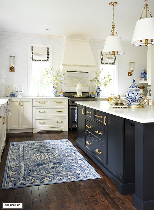 Beautiful fall kitchen decorating with blue and white chinoiserie, a blue southwestern style rug, and gold accessories.
