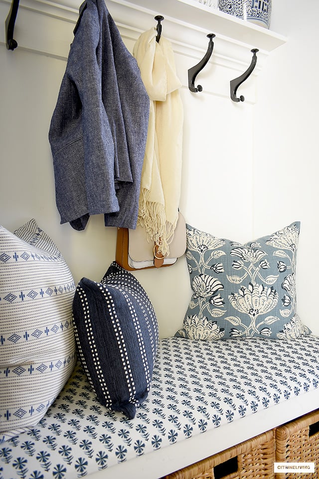 A beautiful builtin bench with gorgeous blue and white fabrics and pillows.