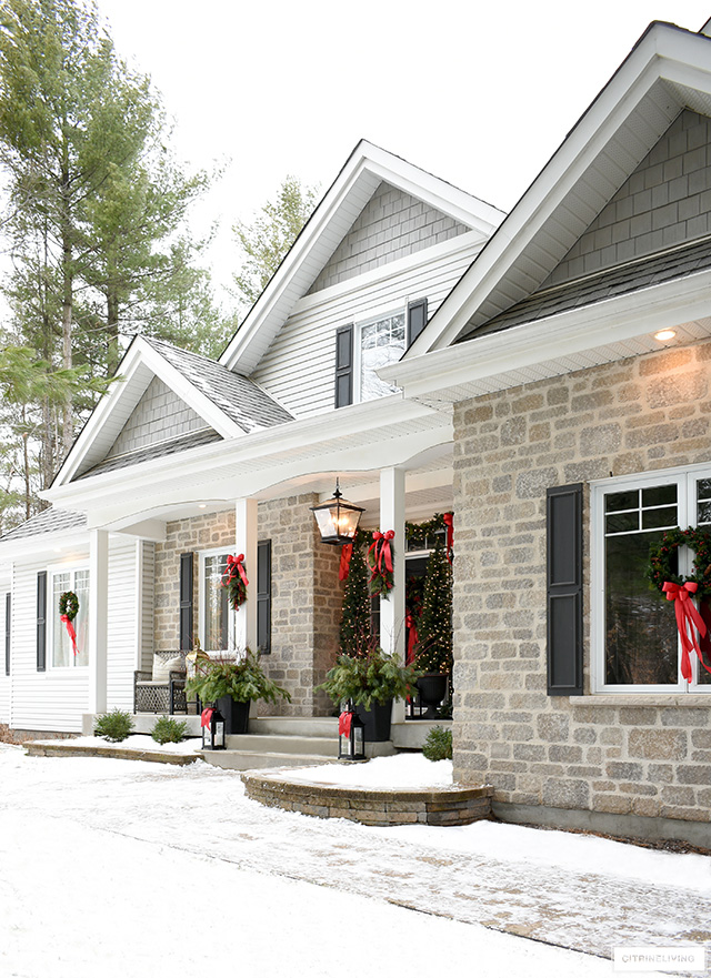 Beautiful Christmas home exterior decorated in classic red for the holidays.