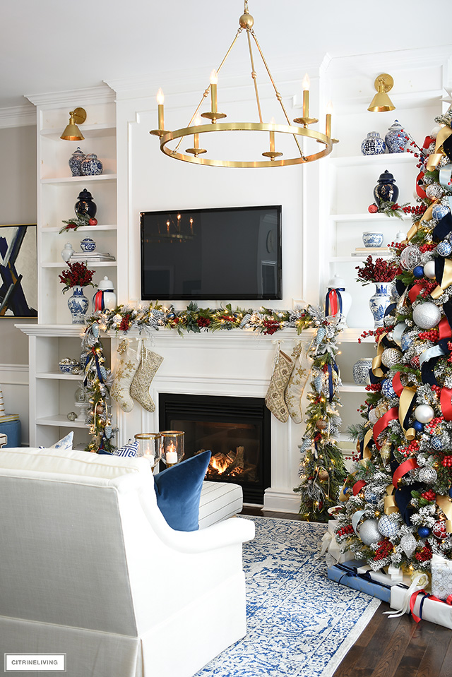Builtin bookshelves and mantel with Christmas garland and stockings.