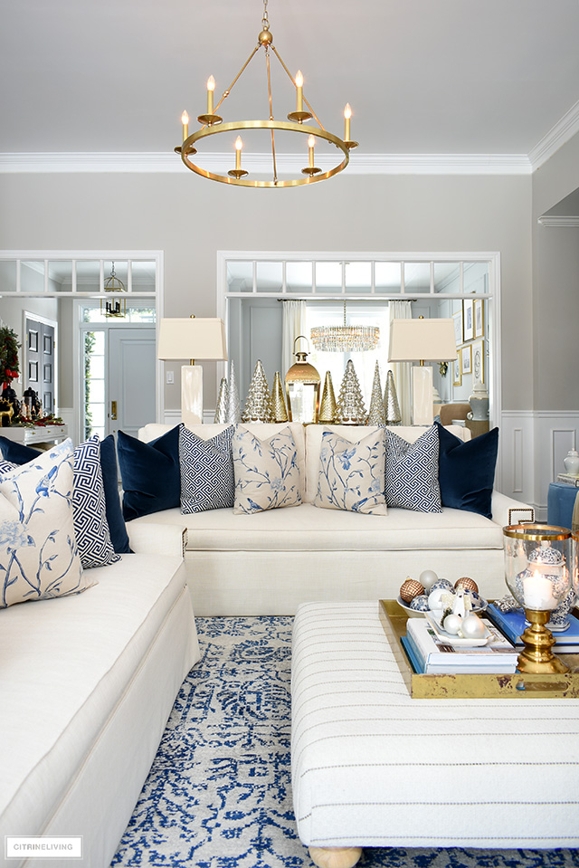 Christmas living room with beautiful blue and white throw pillows, gold and silver accents.