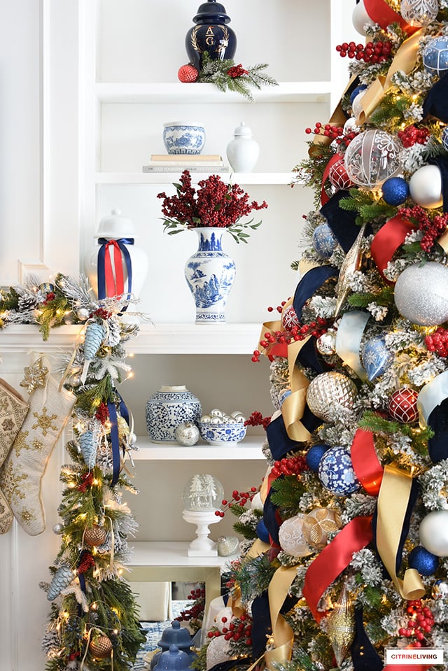 Christmas decorated shelves with ginger jars, vases red berries, pine and ornaments.