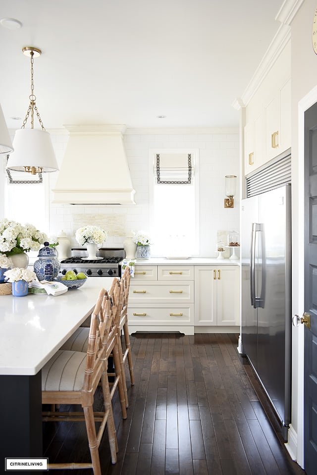 Kitchen decorated for spring with faux flowers and blue and white accents.