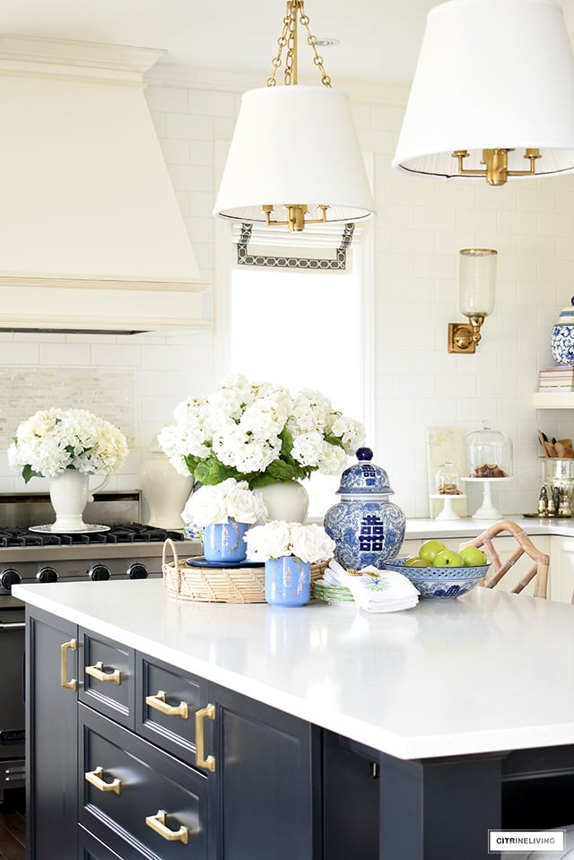 Spring decorated kitchen island with blue and white ginger jars and faux florals.