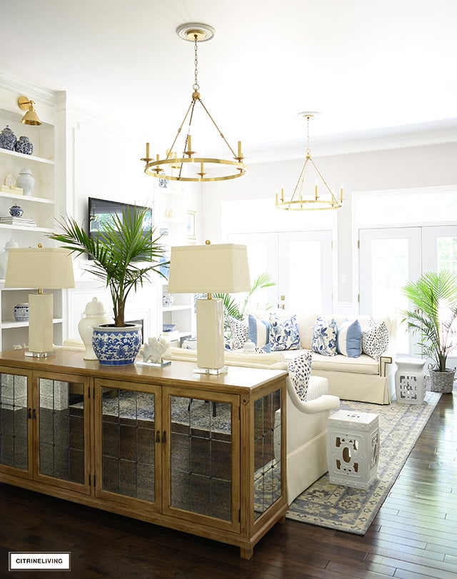 Coastal chic living room summer styled with pops of blue and white hues for summer.