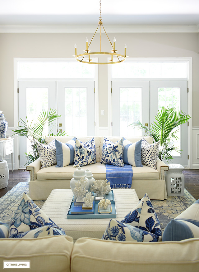 Summer living room decorated in blue and white accented with majesty palms.