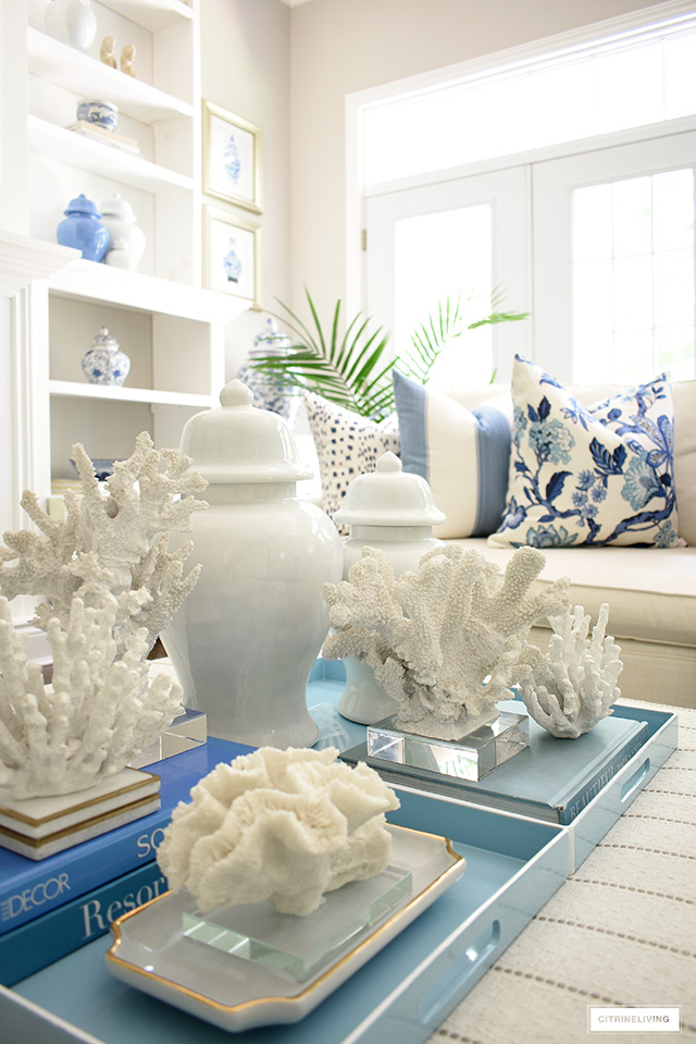 A coastal chic vignette styled with ginger jars and coral sculptures in varying sizes and shapes.