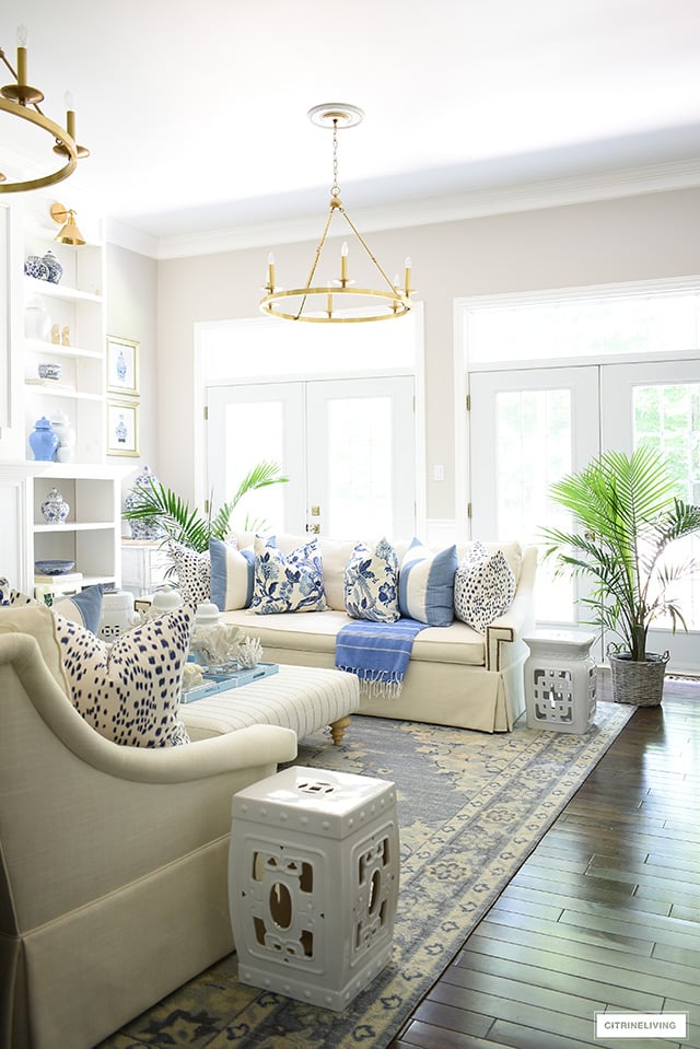 Beautiful living room decorated for summer in a blue and white coastal, Hamptons look.