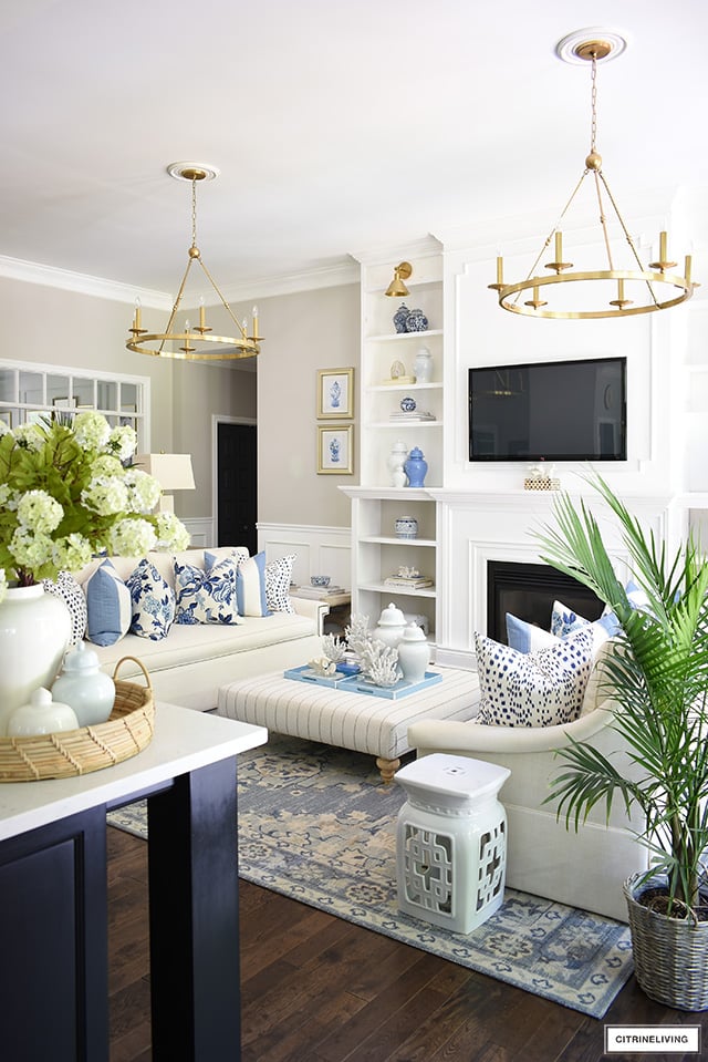 Summer living room decor in blue and white with a hamptons-inspired feel.