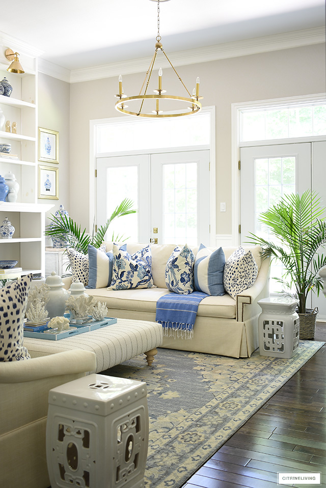 Summer living room decor with blue and white Hamptons-inspired pillows.