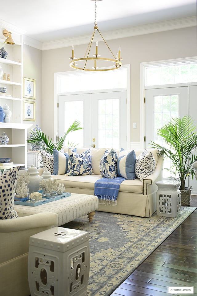 Summer living room decor with blue and white Hamptons-inspired pillows.