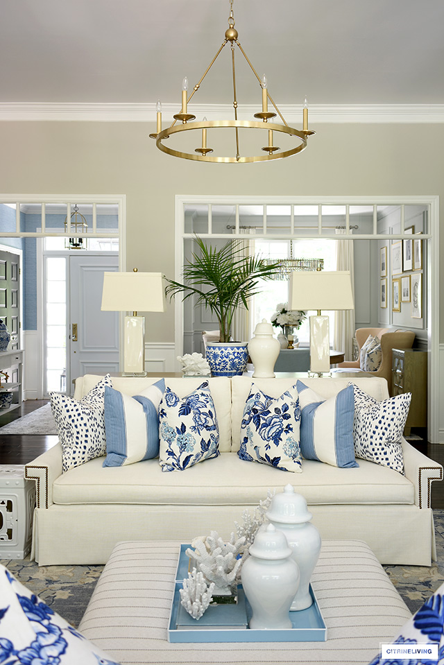 Beautiful summer decorating with blue and white hamptons-style pillows and decor.