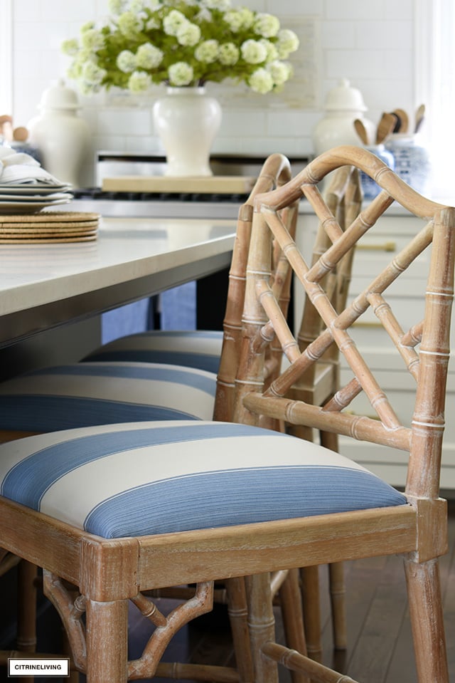 Chic blue and white striped fabric covers this kitchen bar stool seat.