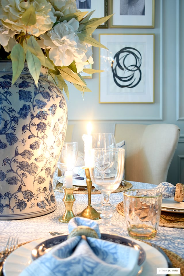 Beautiful candlelit fall tablescape in blue and white with gold accents.