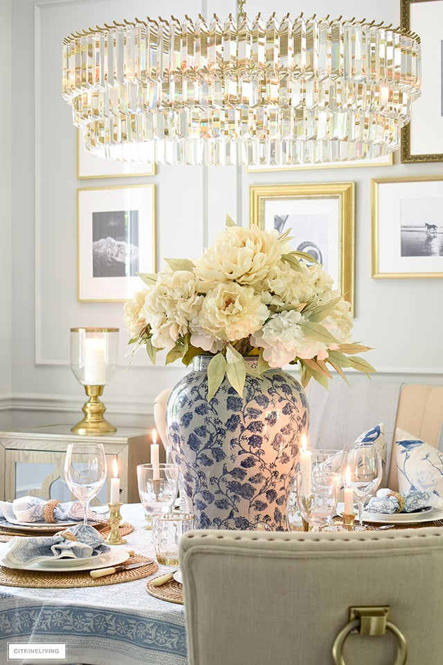 Fall centrepiece with large ginger jar and faux hydrangeas, peonies and greenery in soft, muted colors.