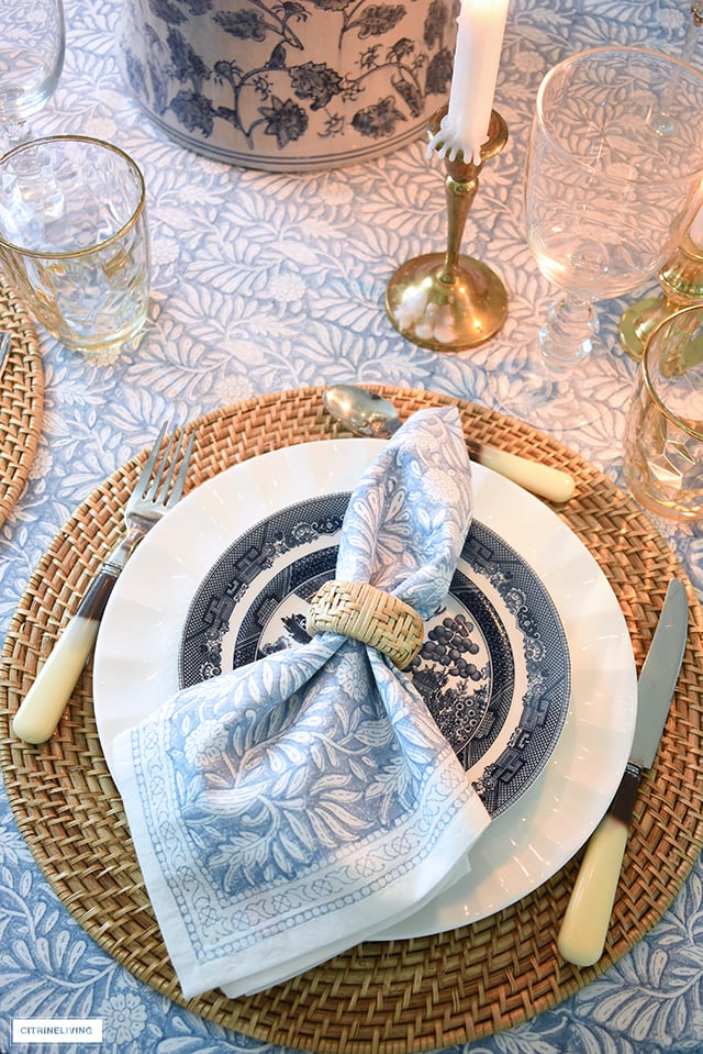 Fall tablescape with woven placemats, chinoiserie dishes and ginger jar, and block print linens.