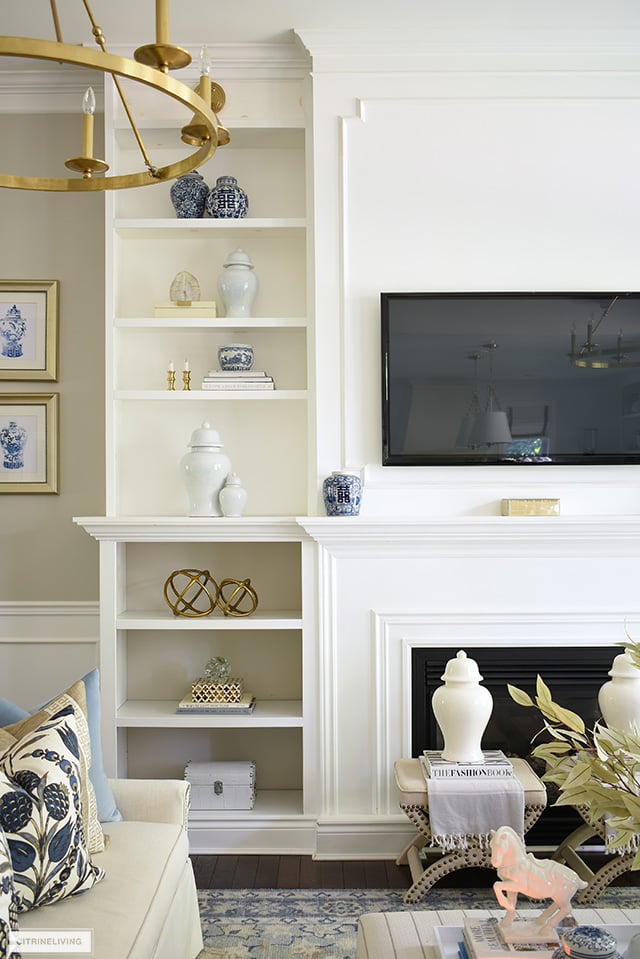 Beautiful and elegant fall styling on bookshelves with ginger jars and simple seasonal accents.