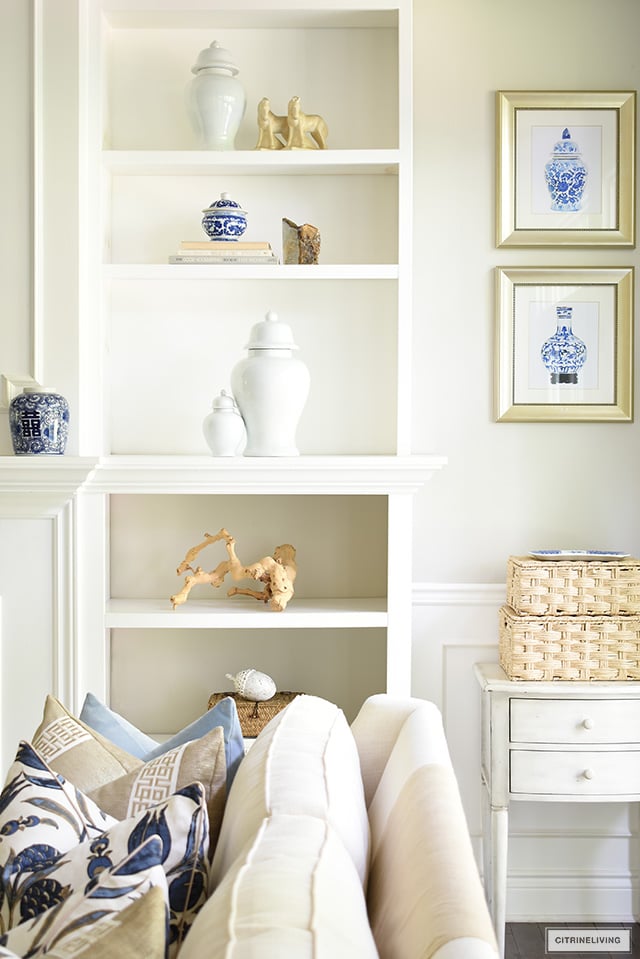 Bookshelf styling with ginger jars, drift wood sculpture and simple accories.