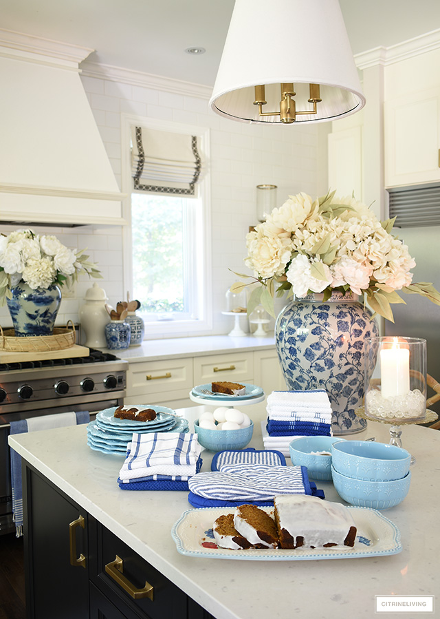 Kitchen island styled for fall with beautiful blue dishes, platter and towel set.
