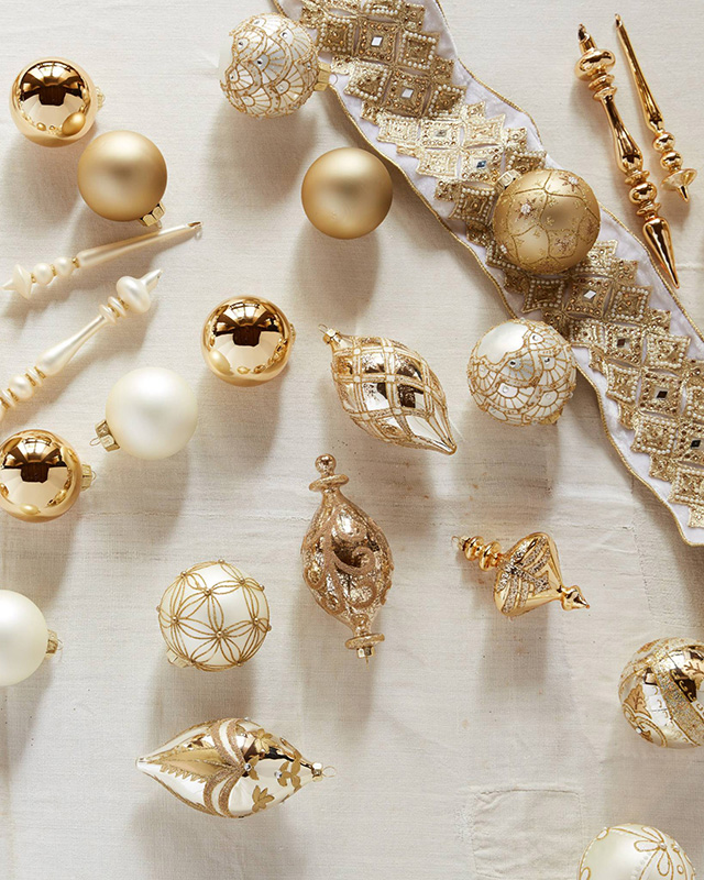 Gold and white Christmas ornaments from the Balsam Hill Biltmore collection.