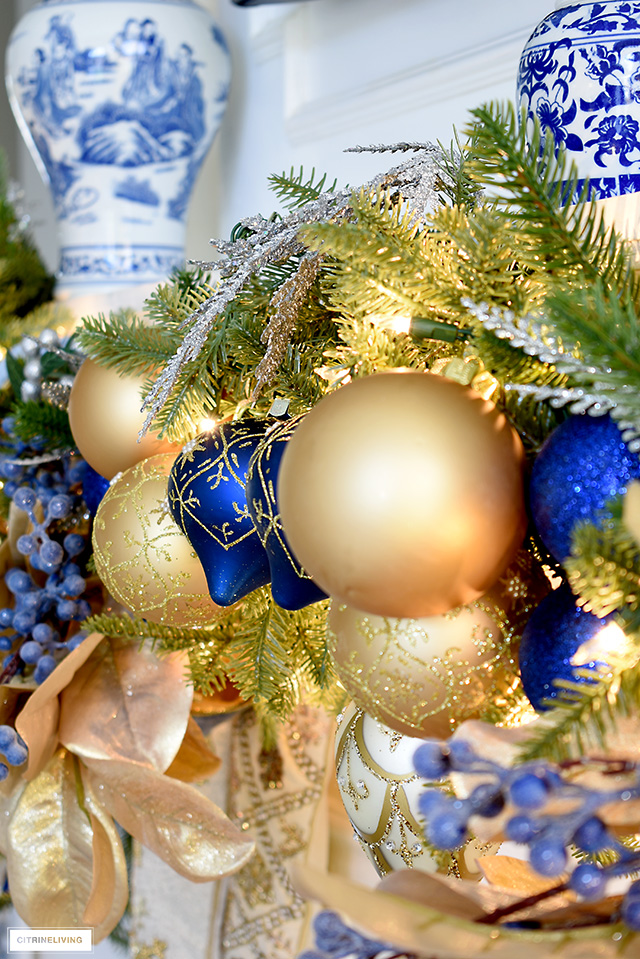 Christmas garland beautifully decorated with blue and gold ornaments.