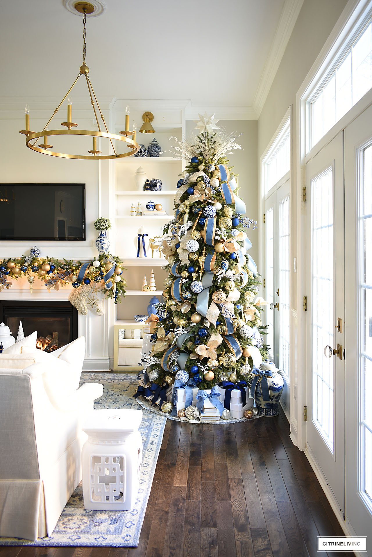 Gorgeous Christmas tree and garland decorated in elegant and timeless blue and gold ornaments and ribbon.
