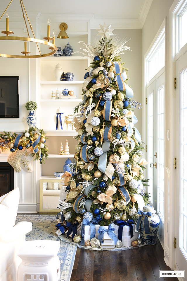 Stunning Christmas tree decorated in elegant and timeless blue and gold ornaments and ribbon.