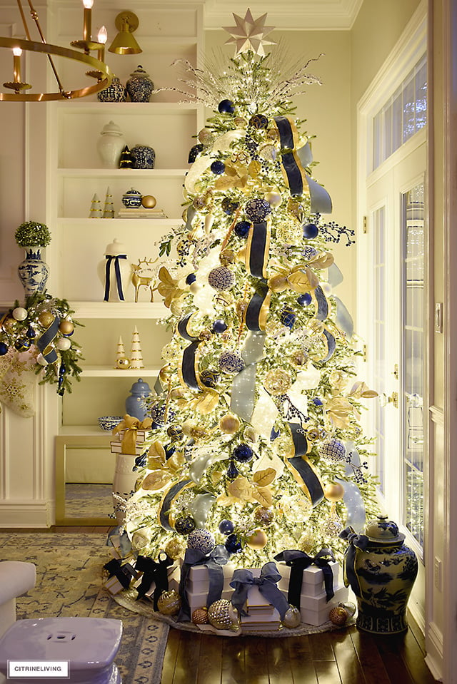 A magical nighttime view of a Christmas tree dressed in blue and gold.