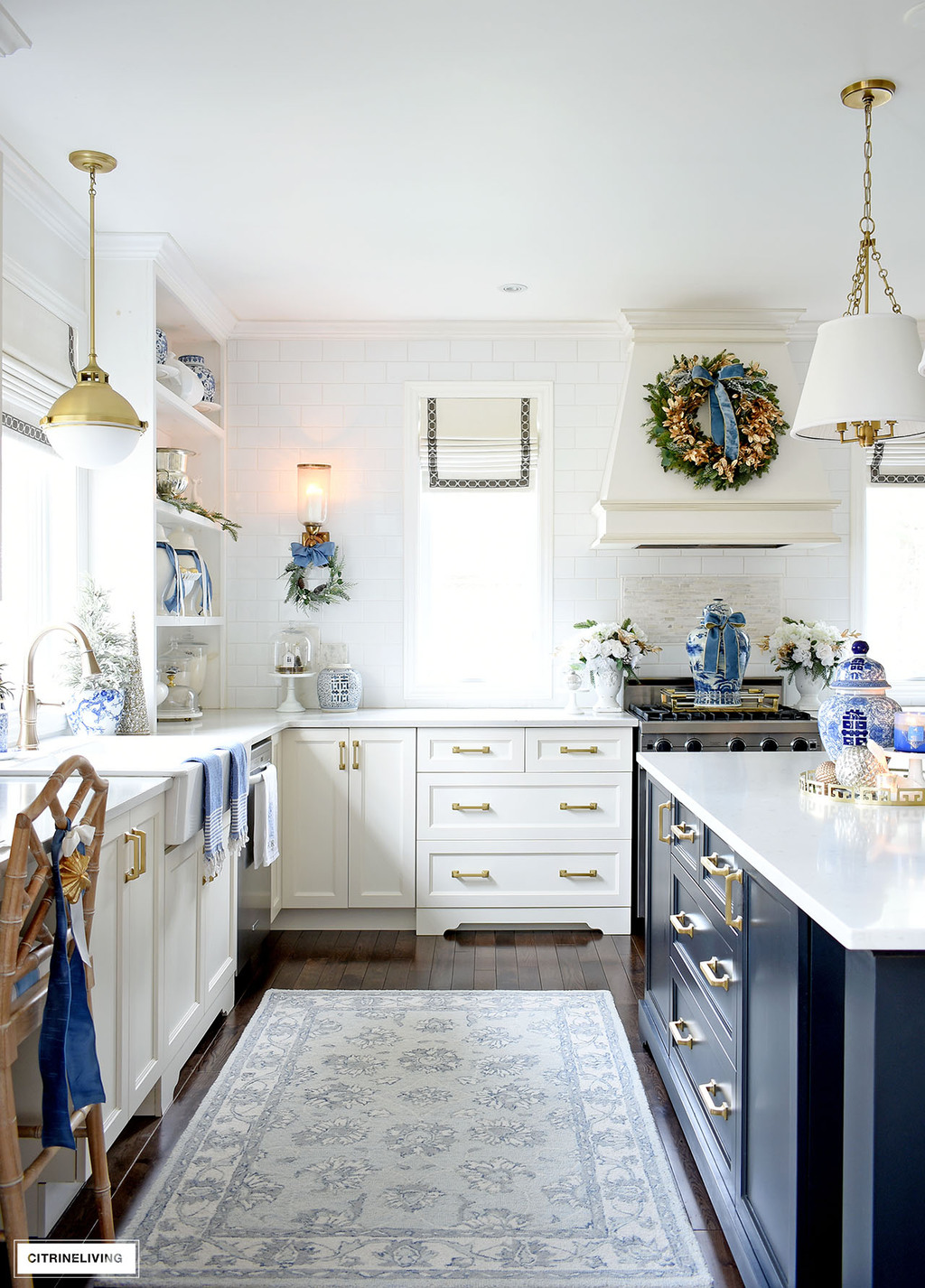 Kitchen decorated for Christmas with blue, white and gold and green wreaths.