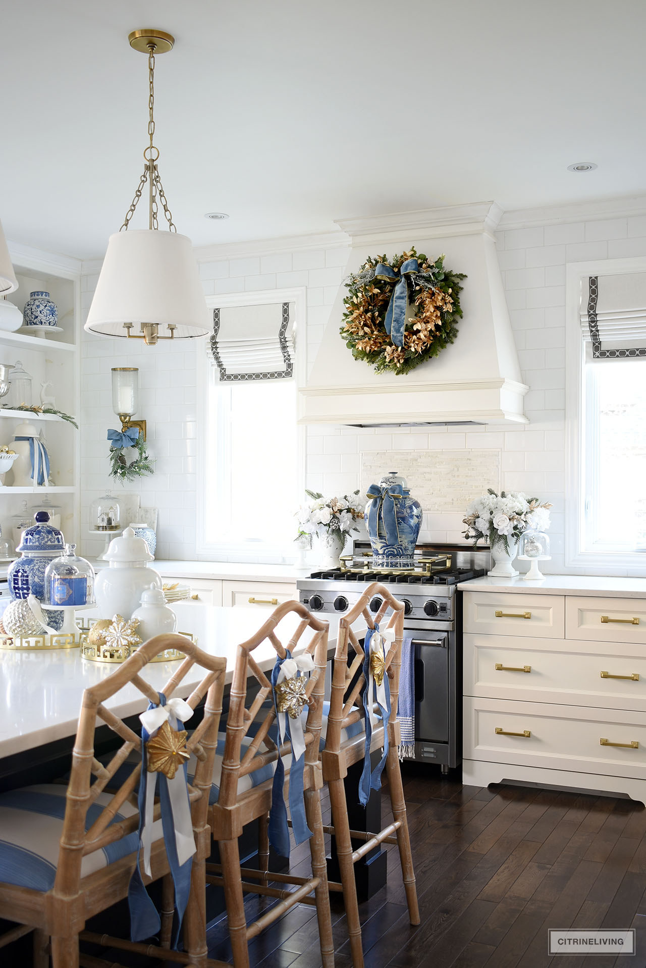 Beautiful and chic Christmas kitchen decor in blue, white and gold with simple greenery touches.