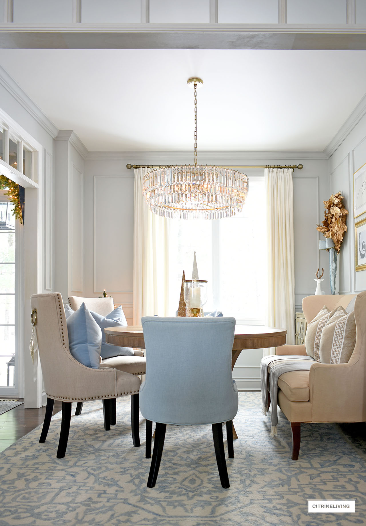 Christmas decorated dining room with simple and elegant decor in blue and gold.