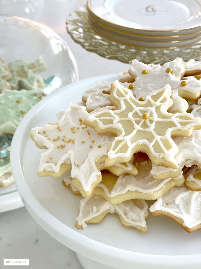 Delicious frosted Christmas cookies styled on beautiful cake stands.