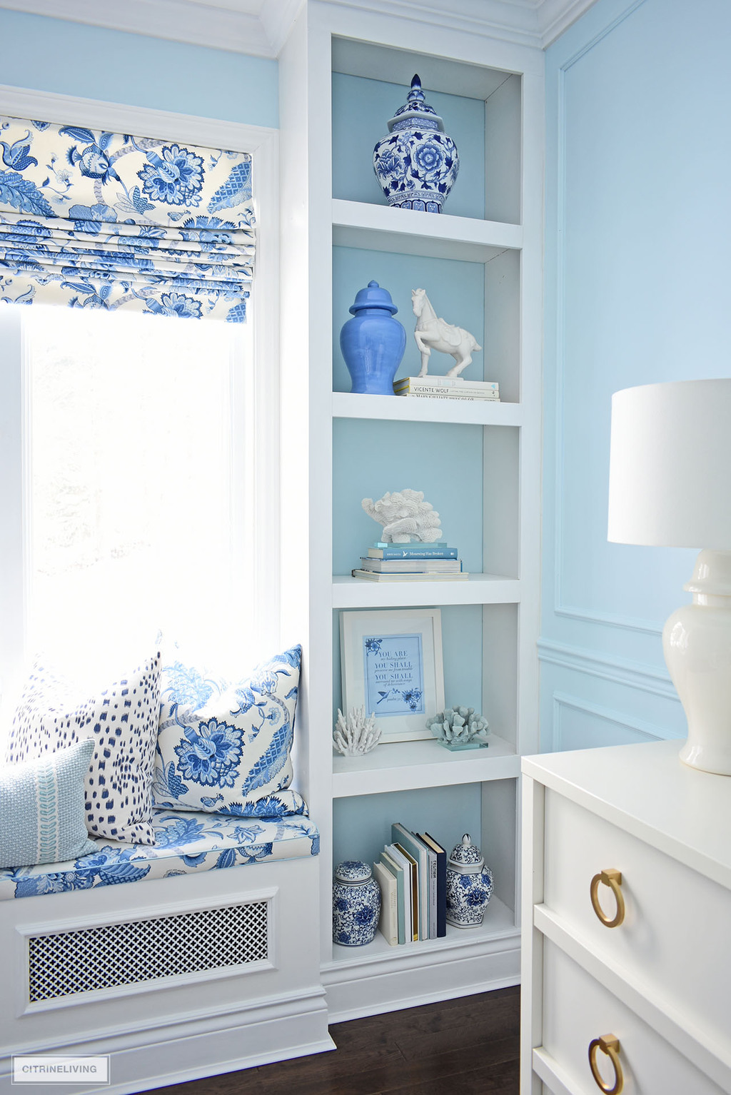 Gorgeous home office builtin shelves styled with beautiful blue and white decor and ginger jars.